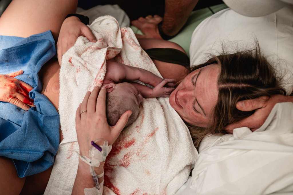 mom holding baby for the first after giving birth