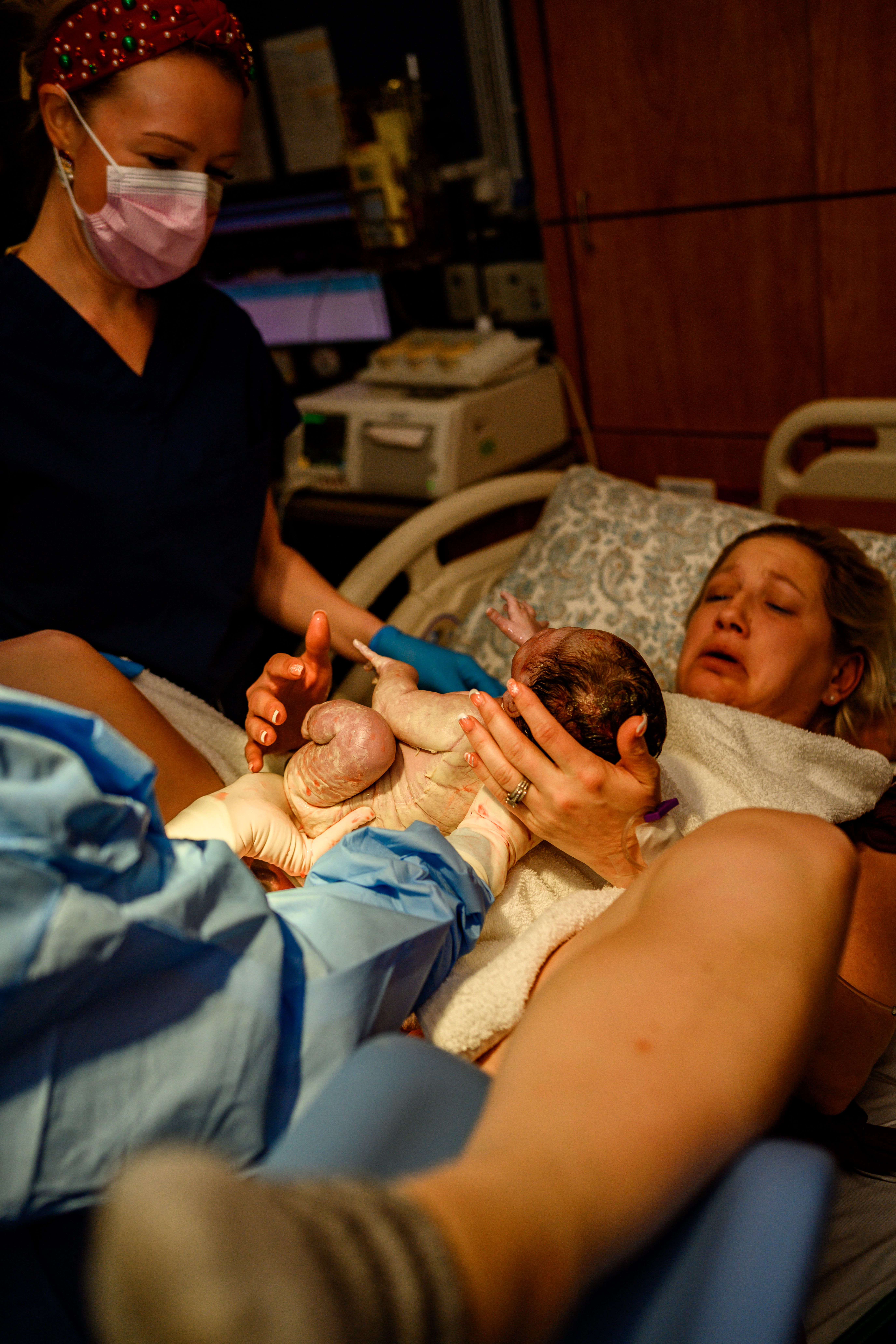 Fort Worth birth photographer capturing an emotional moment as a mother meets her newborn baby