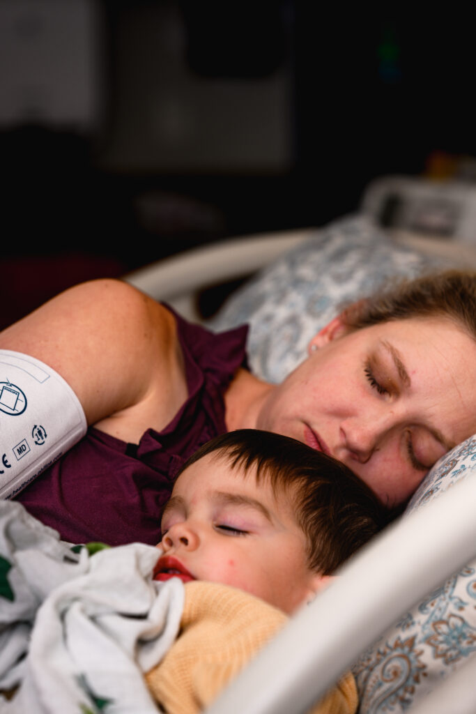 Mom resting with son, why birth photography matters Fort Worth