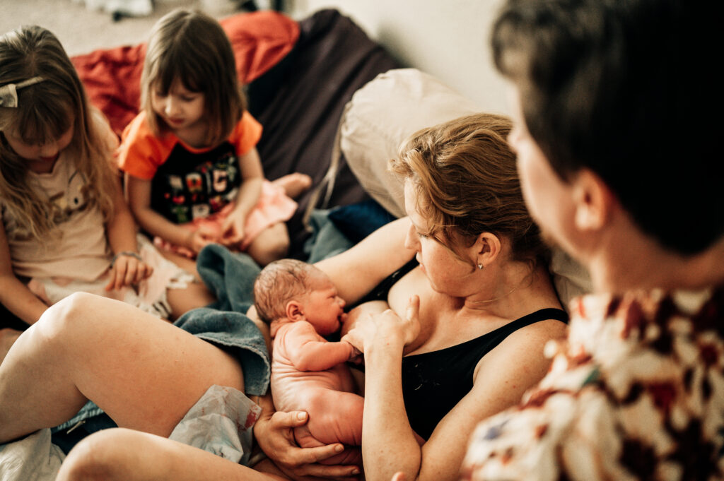 newborn held for the first time after home birth in Fort Worth Texas photographed by DFW birth photogrpher Emily King