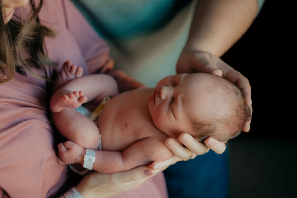 Newborn baby sleeping in a hospital bassinet during a Fort Worth Fresh 48 session.